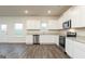 Modern kitchen featuring white cabinets, stainless steel appliances, and granite countertops at 1048 Claas Way, Locust Grove, GA 30248