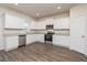 Modern kitchen featuring white cabinets, stainless steel appliances, and granite countertops at 1048 Claas Way, Locust Grove, GA 30248