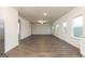 Spacious living room featuring hard surface floors, two windows, and neutral color palette at 1048 Claas Way, Locust Grove, GA 30248