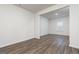 Open-concept living room boasts stylish wood flooring and a bright sunny window at 1048 Claas Way, Locust Grove, GA 30248
