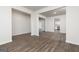 Spacious open-concept living room with hardwood floors and white walls, leading into the kitchen at 1048 Claas Way, Locust Grove, GA 30248