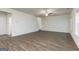 Bright living room with beautiful hard surface floors, ceiling fan, and staircase at 1048 Claas Way, Locust Grove, GA 30248