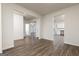 Open-concept living room boasts stylish wood flooring and seamless transitions to other rooms at 1048 Claas Way, Locust Grove, GA 30248