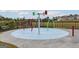 Community splash pad featuring colorful water features and a surrounding fence for safety at 1048 Claas Way, Locust Grove, GA 30248
