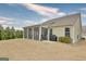 View of backyard featuring a screened-in porch with grill and surrounding greenery at 339 Cottonwood Cir, Peachtree City, GA 30269