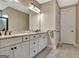 Bathroom with a double sink, granite countertop, white cabinetry, and tiled floor at 339 Cottonwood Cir, Peachtree City, GA 30269