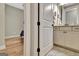 Bathroom with hardwood floors and a partial view of the bathroom with cabinets and mirror at 339 Cottonwood Cir, Peachtree City, GA 30269