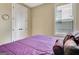 Bedroom view featuring a queen size bed, closet with double doors, and a bright window at 339 Cottonwood Cir, Peachtree City, GA 30269