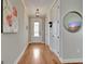 Bright hallway features gleaming hardwood floors and elegant lighting fixtures and access to rooms at 339 Cottonwood Cir, Peachtree City, GA 30269