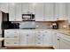 Kitchen featuring white cabinets, granite counters, and stainless steel appliances at 339 Cottonwood Cir, Peachtree City, GA 30269