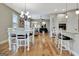 Open concept kitchen with white cabinetry, hardwood floors and an adjacent living area at 339 Cottonwood Cir, Peachtree City, GA 30269