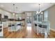 Bright, open-concept kitchen and dining area with wood floors and ample seating at 339 Cottonwood Cir, Peachtree City, GA 30269