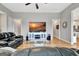 Open living room with TV, hardwood floors, and comfortable seating, perfect for relaxation at 339 Cottonwood Cir, Peachtree City, GA 30269