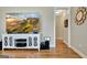 Comfortable living room with a TV above a white cabinet and natural light through an open doorway at 339 Cottonwood Cir, Peachtree City, GA 30269