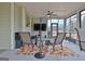 Relaxing sunroom with a ceiling fan, TV, seating and views of the backyard at 339 Cottonwood Cir, Peachtree City, GA 30269