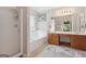 Bright bathroom featuring a soaking tub, separate shower, dual sink vanity, and neutral finishes at 260 Millbrook Village Dr, Tyrone, GA 30290