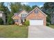 Charming two-story brick home with a well-manicured lawn and a two-car garage at 260 Millbrook Village Dr, Tyrone, GA 30290