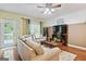Comfortable living room with a ceiling fan, hardwood floors, and a large sectional sofa at 260 Millbrook Village Dr, Tyrone, GA 30290