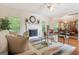 Bright living room featuring hardwood floors, fireplace, and open layout at 260 Millbrook Village Dr, Tyrone, GA 30290
