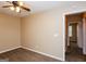 Bedroom featuring a ceiling fan, neutral walls and view of a hallway with natural lighting at 5797 Strathmoor Manor Cir, Lithonia, GA 30058