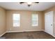Bedroom featuring carpet, neutral walls, and two windows with blinds at 5797 Strathmoor Manor Cir, Lithonia, GA 30058