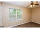 Bedroom with neutral walls, ceiling fan, and window that offers natural light at 5797 Strathmoor Manor Cir, Lithonia, GA 30058