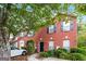 Charming brick townhome with manicured landscaping and a walkway leading to a black front door at 5797 Strathmoor Manor Cir, Lithonia, GA 30058