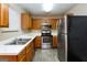 Kitchen featuring stainless steel appliances, wooden cabinets, and tiled floors at 5797 Strathmoor Manor Cir, Lithonia, GA 30058