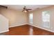 A spacious living room features wood floors, neutral walls, and two large windows with blinds at 5797 Strathmoor Manor Cir, Lithonia, GA 30058
