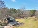 Aerial view of the property featuring a large backyard, outbuilding, and mature trees, showcasing the expansive lot at 74 Price W Dr, Locust Grove, GA 30248