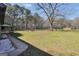 Expansive backyard featuring a large lawn, mature trees, and an outbuilding, perfect for outdoor activities at 74 Price W Dr, Locust Grove, GA 30248