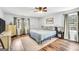 Serene main bedroom features cozy decor, a ceiling fan, and wood-look flooring at 74 Price W Dr, Locust Grove, GA 30248