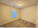 Cozy bedroom featuring neutral carpet, ample light, and a minimalist design at 3750 Greenbrook Dr, Douglasville, GA 30135