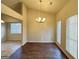 Well-lit dining room with dark wood flooring, chandelier, and large windows at 3750 Greenbrook Dr, Douglasville, GA 30135
