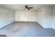 Spacious living room with a ceiling fan, carpeted floors, and 2 closets at 3750 Greenbrook Dr, Douglasville, GA 30135