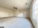 Large carpeted living room with two doors and a ceiling fan at 3750 Greenbrook Dr, Douglasville, GA 30135