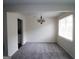 Bright living room with neutral carpet, chandelier, and a large window at 905 Pine Tree Trl, South Fulton, GA 30349