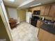 Functional kitchen featuring tile floors, wooden cabinets, and essential appliances at 24 Picketts Mill Pl, Acworth, GA 30101