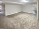 Finished basement space with neutral carpet, and an open layout, ready for customization at 1280 Pinyon Pl, Lawrenceville, GA 30043