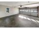Spacious two-car garage featuring concrete floor, windows, and ample space for storage at 1280 Pinyon Pl, Lawrenceville, GA 30043