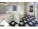 Bright bathroom featuring dual sink vanity, decorative floors, and soaking tub at 1280 Pinyon Pl, Lawrenceville, GA 30043