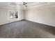 The primary bedroom has gray carpet, trey ceilings with a ceiling fan, and a large window at 1280 Pinyon Pl, Lawrenceville, GA 30043
