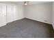 This bedroom has gray carpet flooring, fresh white walls, a ceiling fan, and a large closet at 1280 Pinyon Pl, Lawrenceville, GA 30043