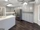 The kitchen has gray cabinets, stainless steel appliances, and a center island with light countertops at 1280 Pinyon Pl, Lawrenceville, GA 30043