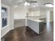 The kitchen has gray cabinets, light countertops, a view to the living room, and dark wooden floors at 1280 Pinyon Pl, Lawrenceville, GA 30043
