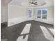 Empty bonus room with carpet, tray ceilings, two windows, and wainscoting on the walls at 1280 Pinyon Pl, Lawrenceville, GA 30043