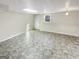 Unfinished basement area with vinyl flooring, a drop ceiling, and a window for natural light at 1280 Pinyon Pl, Lawrenceville, GA 30043