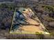 Aerial view of the lot with property lines outlined and the home in the distance at 550 Stateline Rd, Bowdon, GA 30108