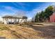 Exterior view of a house with a large backyard, wooden deck, and shed at 550 Stateline Rd, Bowdon, GA 30108