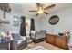 Light-filled bedroom featuring a ceiling fan, hardwood floors, and a comfortable crib at 550 Stateline Rd, Bowdon, GA 30108
